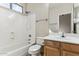 Bathroom with tub shower combo, toilet and wood vanity at 19435 N 62Nd Ave, Glendale, AZ 85308