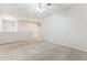 Spacious living room with carpeted floors and ceiling fan at 19435 N 62Nd Ave, Glendale, AZ 85308