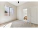 Cozy bedroom with window, carpet, and access to a full bathroom at 19435 N 62Nd Ave, Glendale, AZ 85308