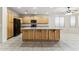 Kitchen boasts an island, ample cabinetry, and modern appliances at 19435 N 62Nd Ave, Glendale, AZ 85308