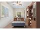 Home office with built-in shelving and large windows at 14428 E Monument Dr, Scottsdale, AZ 85262