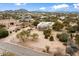 Aerial view of a house on a large lot with mountain views at 14428 E Monument Dr, Scottsdale, AZ 85262