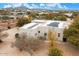 Aerial view of a house with solar panels and a landscaped yard at 14428 E Monument Dr, Scottsdale, AZ 85262