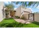 Landscaped front yard with artificial turf and brick path at 14428 E Monument Dr, Scottsdale, AZ 85262