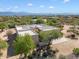 Aerial view of a sprawling property with desert landscaping and mountain backdrop at 14428 E Monument Dr, Scottsdale, AZ 85262
