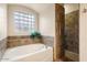 Bathroom with soaking tub, shower, and tile flooring at 14428 E Monument Dr, Scottsdale, AZ 85262