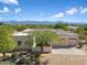 Aerial view of a single-story home with a large yard and mountain views at 14428 E Monument Dr, Scottsdale, AZ 85262