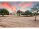 Desert backyard view of home at sunset at 14428 E Monument Dr, Scottsdale, AZ 85262