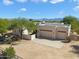 Aerial view of a stucco home with a double garage and mountain views at 14428 E Monument Dr, Scottsdale, AZ 85262