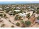 Aerial view showcasing a house with solar panels and desert landscape at 14428 E Monument Dr, Scottsdale, AZ 85262