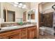 Bathroom with double vanity, wood cabinets and shower/tub combo at 14428 E Monument Dr, Scottsdale, AZ 85262