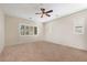 Spacious bedroom with ceiling fan and neutral carpeting at 14428 E Monument Dr, Scottsdale, AZ 85262