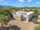 Aerial view showcasing a large home with solar panels and mountain views at 14428 E Monument Dr, Scottsdale, AZ 85262
