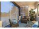 Spacious screened-in porch with wicker furniture, creating an outdoor oasis at 14428 E Monument Dr, Scottsdale, AZ 85262