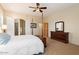 Spacious bedroom with a post bed, dresser, and ensuite bathroom at 14428 E Monument Dr, Scottsdale, AZ 85262