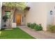 Inviting front entry with a wooden door and landscaped walkway at 14428 E Monument Dr, Scottsdale, AZ 85262