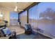 Relaxing screened porch with wicker furniture and ceiling fan at 14428 E Monument Dr, Scottsdale, AZ 85262