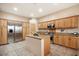 Spacious kitchen with island, stainless steel appliances, and light wood cabinets at 14428 E Monument Dr, Scottsdale, AZ 85262