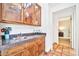 Wet bar with granite countertop and wooden cabinets at 9252 E Whitethorn Cir, Scottsdale, AZ 85266