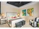 Comfortable guest bedroom with two ottomans and artwork at 37200 N Cave Creek Rd # 1126, Scottsdale, AZ 85262