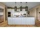 Modern kitchen with white cabinets, large island, and high-end appliances at 37200 N Cave Creek Rd # 1126, Scottsdale, AZ 85262