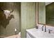 Modern powder room with unique wallpaper and dark fixtures at 37200 N Cave Creek Rd # 1126, Scottsdale, AZ 85262