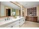 Spa-like bathroom with double vanity and decorative wallpaper at 37200 N Cave Creek Rd # 1126, Scottsdale, AZ 85262