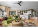 Open living space with green sofa and view into modern kitchen at 37200 N Cave Creek Rd # 1126, Scottsdale, AZ 85262