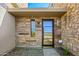 Modern front door with glass panels and stone facade at 37200 N Cave Creek Rd # 1126, Scottsdale, AZ 85262
