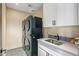 Modern laundry room with washer, dryer, and utility sink at 37200 N Cave Creek Rd # 1126, Scottsdale, AZ 85262