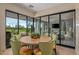 Casual dining area with light wood table and access to a patio at 37200 N Cave Creek Rd # 1126, Scottsdale, AZ 85262