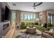 Bright living room featuring a fireplace, large windows, and a green sectional sofa at 37200 N Cave Creek Rd # 1126, Scottsdale, AZ 85262