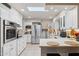 Modern kitchen with stainless steel appliances and white cabinets at 10317 W Prairie Hills Cir, Sun City, AZ 85351