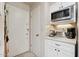 White kitchen cabinets, microwave, coffee maker and toaster at 10317 W Prairie Hills Cir, Sun City, AZ 85351
