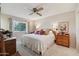 King size bed in spacious main bedroom with ceiling fan at 10317 W Prairie Hills Cir, Sun City, AZ 85351