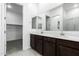 Double vanity bathroom with dark brown cabinets and a shower at 7366 E White Tail Rd, San Tan Valley, AZ 85143