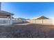 Backyard with block wall and under construction homes at 7366 E White Tail Rd, San Tan Valley, AZ 85143
