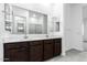 Double vanity bathroom with dark brown cabinets and large mirror at 7366 E White Tail Rd, San Tan Valley, AZ 85143