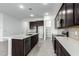 Modern kitchen with dark cabinetry and breakfast bar at 7366 E White Tail Rd, San Tan Valley, AZ 85143