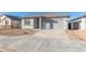 Newly built single-story home with gray siding and a two-car garage at 7366 E White Tail Rd, San Tan Valley, AZ 85143