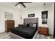 Large bedroom with gray upholstered bed and wood furniture at 20428 W Elm Dr, Buckeye, AZ 85396