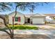 Single-story home with a landscaped lawn, two-car garage, and red shutters at 20428 W Elm Dr, Buckeye, AZ 85396