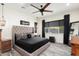Spacious main bedroom with a large bed, ceiling fan, and wood dresser at 20428 W Elm Dr, Buckeye, AZ 85396
