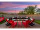 Cozy backyard fire pit with seating and mountain views at 20428 W Elm Dr, Buckeye, AZ 85396
