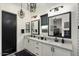 Modern bathroom with double vanity, black accents, and large mirrors at 20428 W Elm Dr, Buckeye, AZ 85396