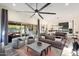 Open living space with gray sofas, a large TV, and view into the kitchen at 20428 W Elm Dr, Buckeye, AZ 85396