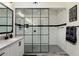 Spa-like bathroom with walk-in shower and black framed glass enclosure at 20428 W Elm Dr, Buckeye, AZ 85396