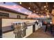 Stainless steel outdoor kitchen with grill and bar seating at 20428 W Elm Dr, Buckeye, AZ 85396
