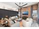 Spacious living room featuring a brick accent wall and a ceiling fan at 20428 W Elm Dr, Buckeye, AZ 85396