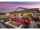 Spacious backyard patio with fire pit, seating area, and built-in BBQ at 20428 W Elm Dr, Buckeye, AZ 85396